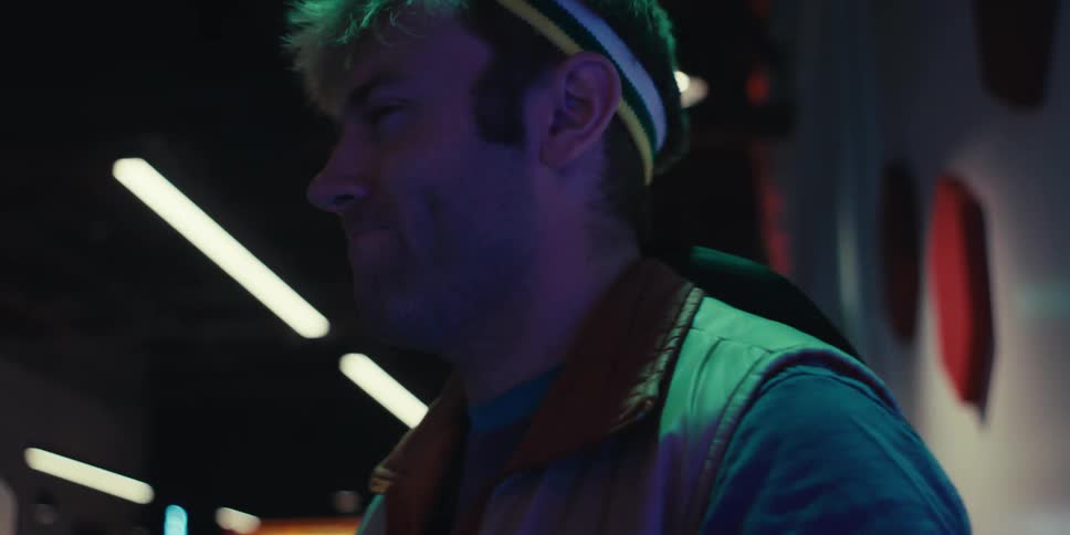 Man losing an arcade game returns to playing it with determination