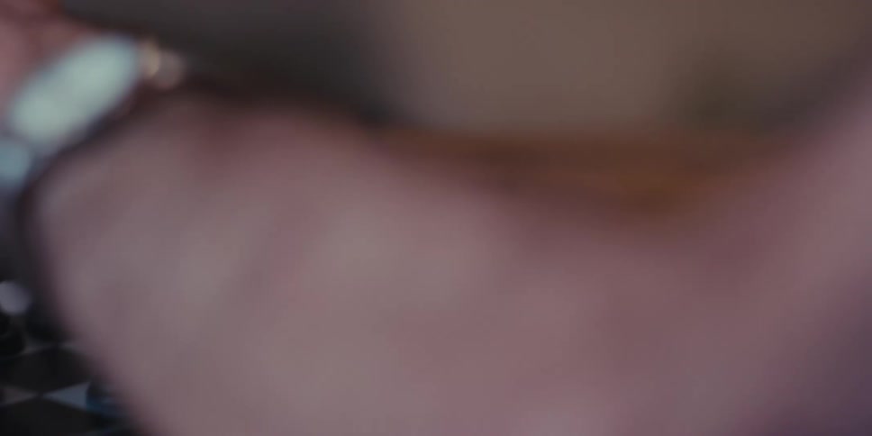 Close up of an elderly man playing chess alone at home