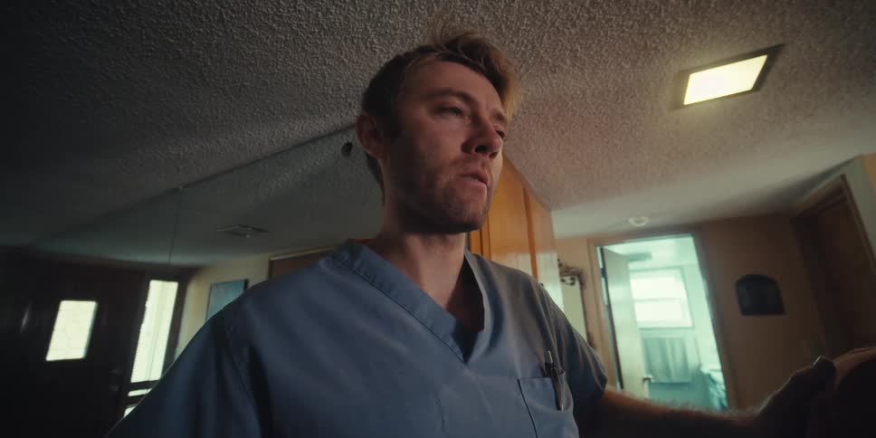 Nurse taking deep breaths with an elderly patient