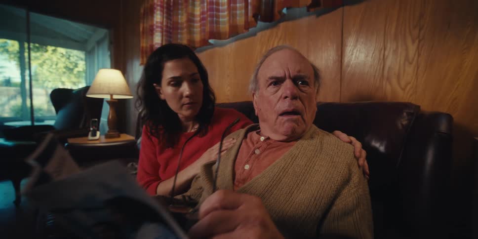 A man gets angry as he reads a brochure