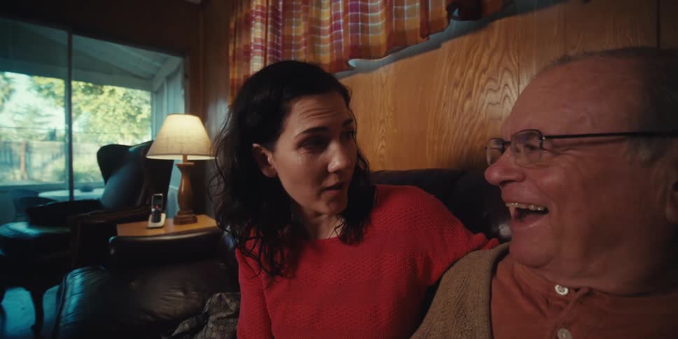 A father and daughter talk and laugh