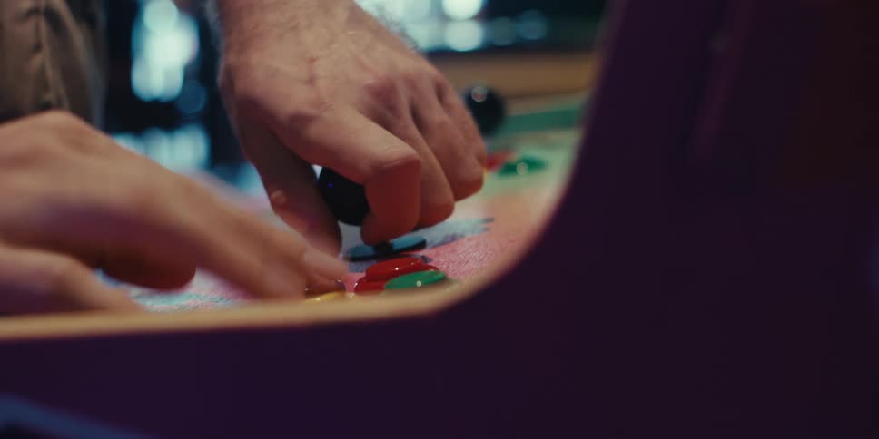 A man is playing a game in the arcade
