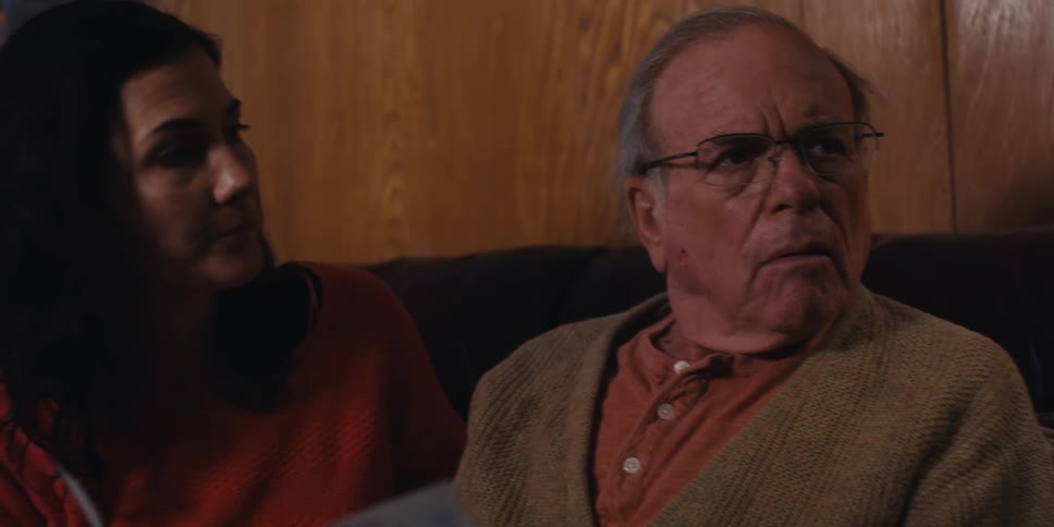 A father and daughter are listening to someone talk