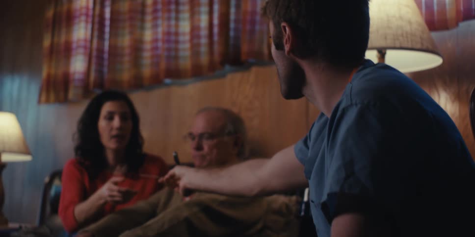 Father and daughter talk to a medical professional during a home visit