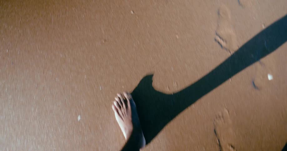 A clip of a person walking on the beach