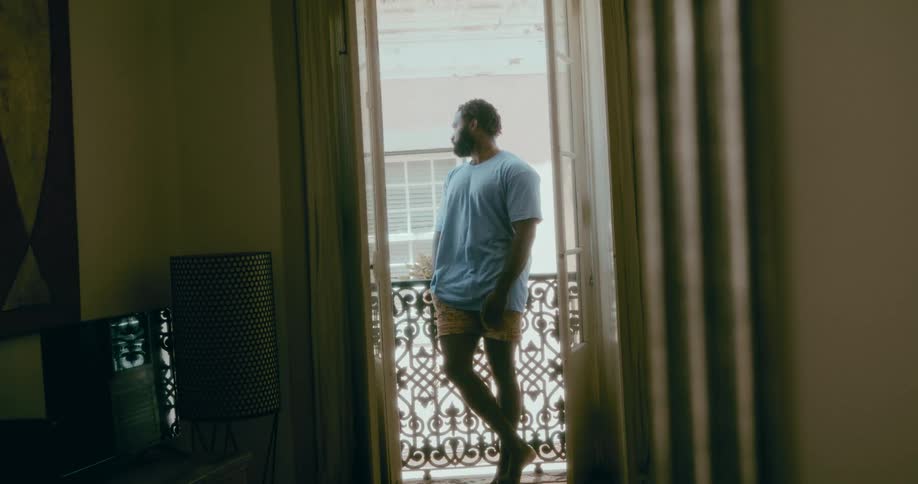 Man relaxing on the porch of a house