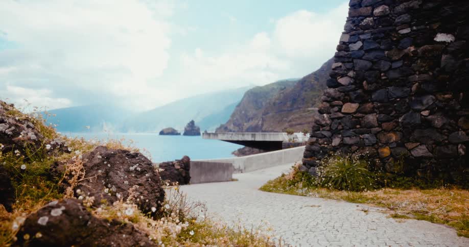 Landscape of a path between rocks leading to the sea in the background