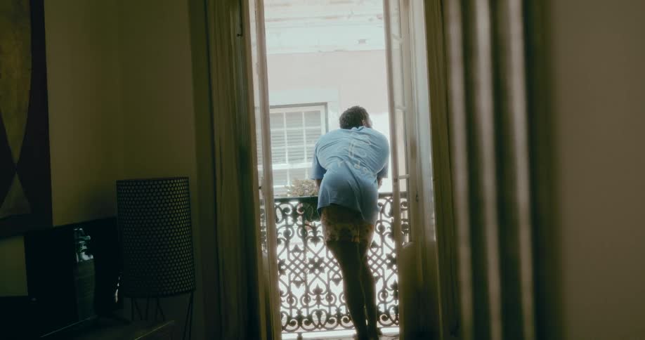 Man on the balcony of a room