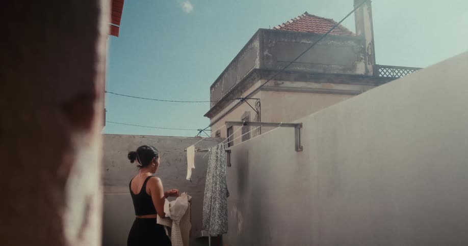 A footage of a lady parking her cloths from the hanger