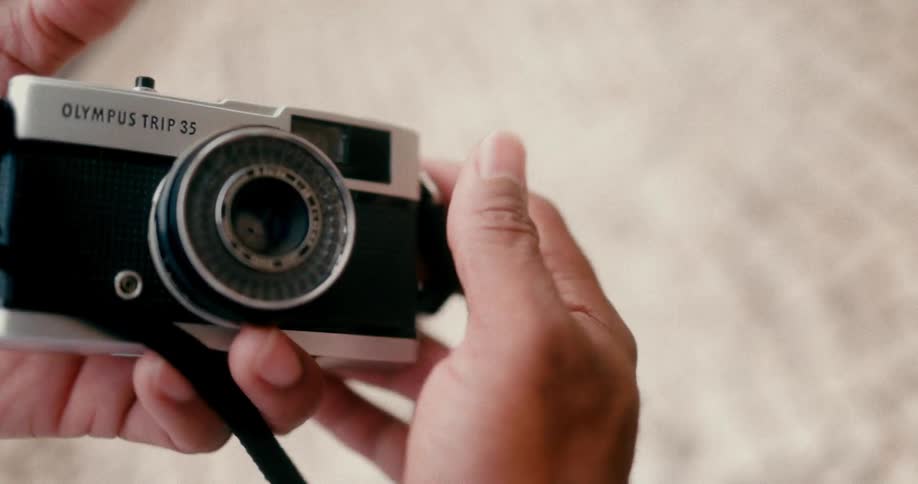 Pair of hands cleaning a vintage camera
