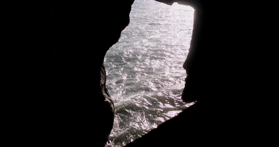 View of calm ocean waters through a rocky crevice