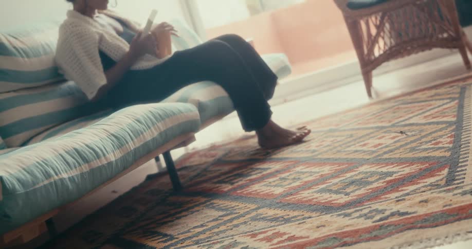 A medium clip of a lady sitting in the living room