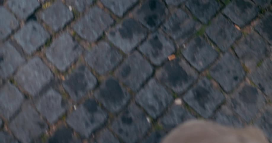 Feet of a person wearing white sneakers walking