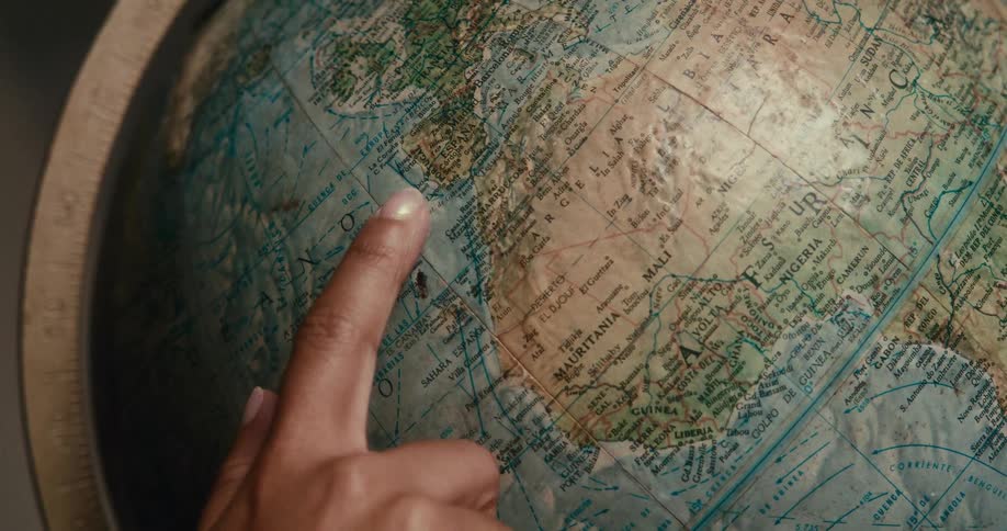 Persons finger interacting with a globe