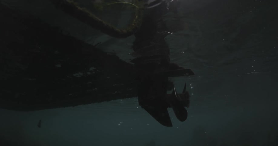 A boat propeller is stopped as the boat rests in the water