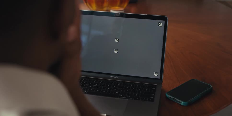 Pair of hands of a person interacting in front of an open laptop