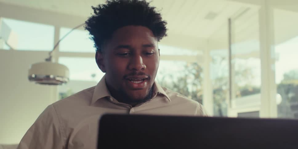 Man sitting in front of a laptop in a meeting