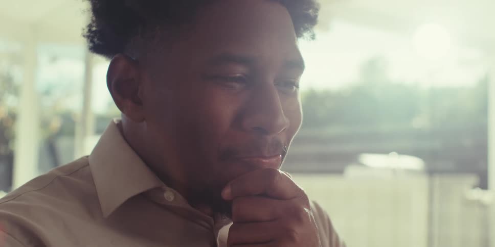 Portrait of a man looking forward and nodding his head