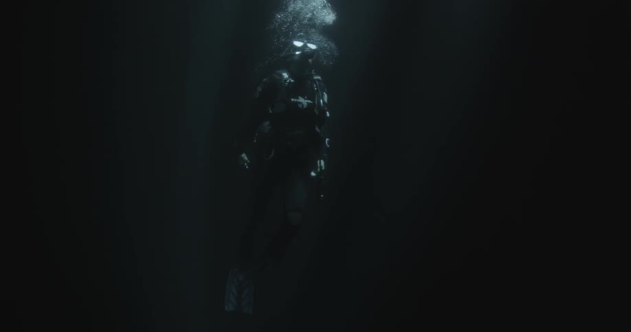 A scuba diver ascends to the surface