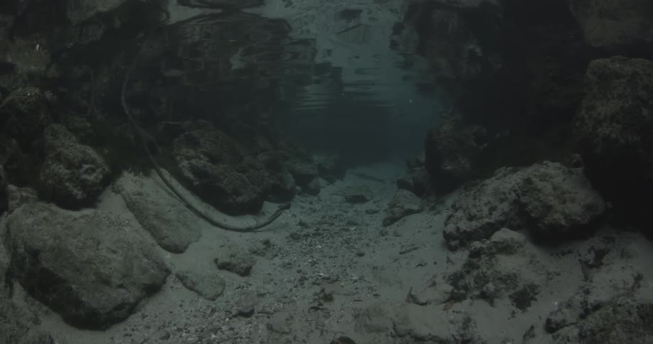 Under the water is covered with large rocks and sand