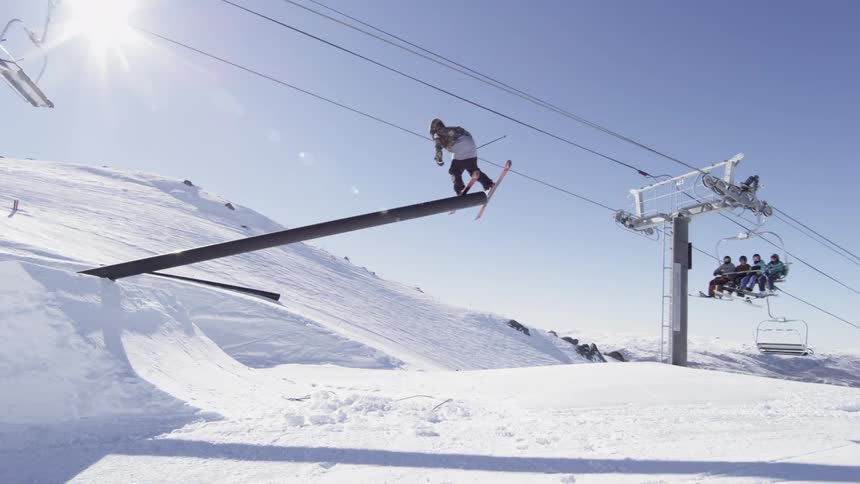 Man does a jump off a slope on a sunny day