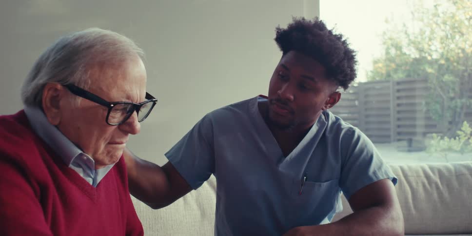 A nurse consoles a worried patient