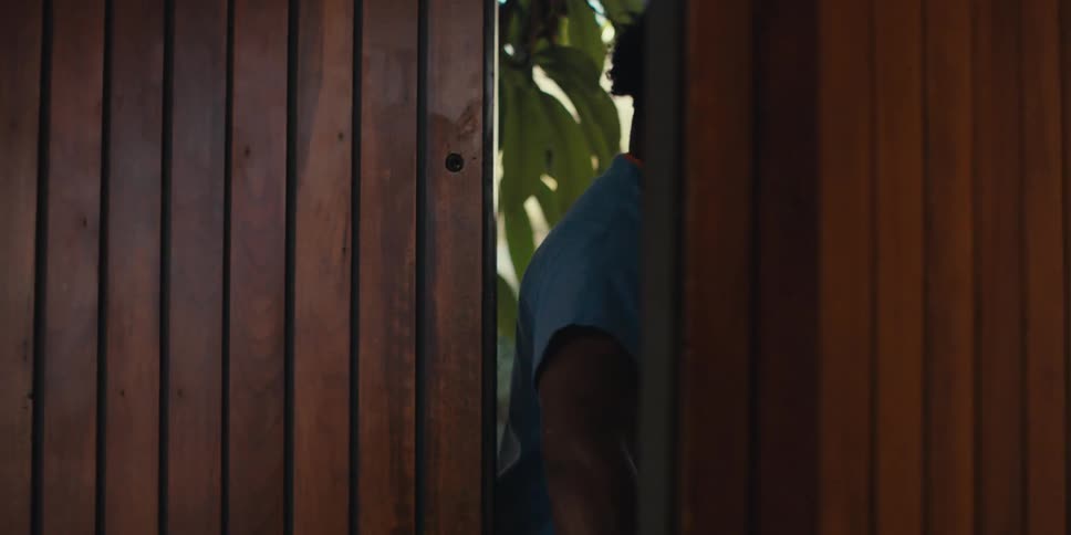 A healthcare worker closes the door as a patient enters