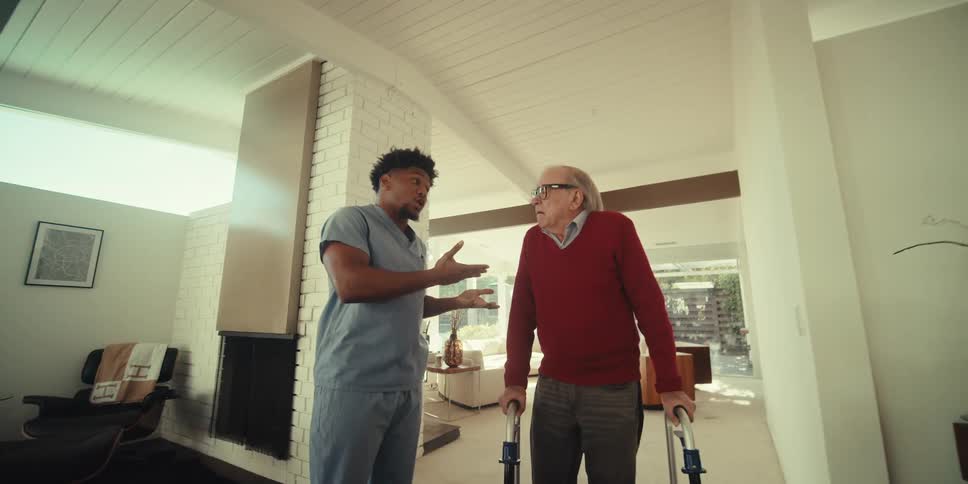 A nurse is talking with a patient in the lobby
