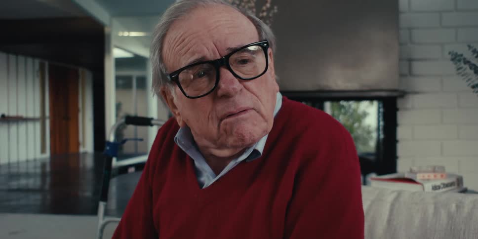 Young man sitting next to an elderly man talking to each other