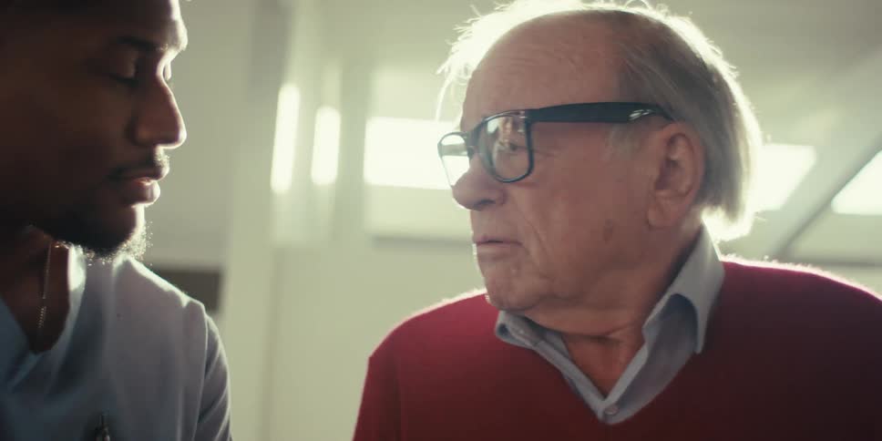Portrait of a young man talking to an elderly man