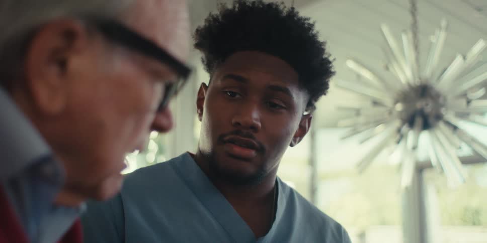 Elderly man looks upset after talking to a home care professional in his home