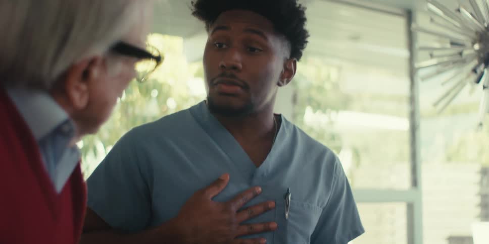 A healthcare provider is talking with a patient as they walk