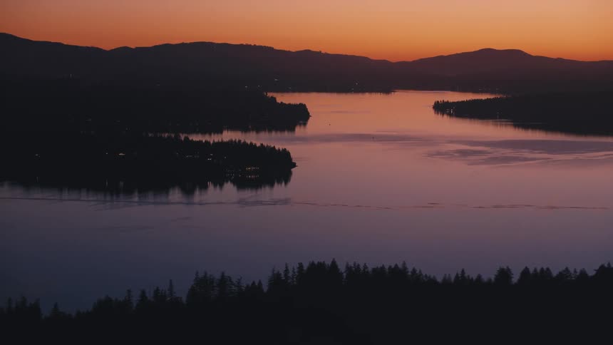 The sun is rising on the river