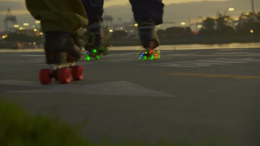 Legs of two people rollerblading