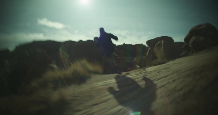 A man races past the boulders