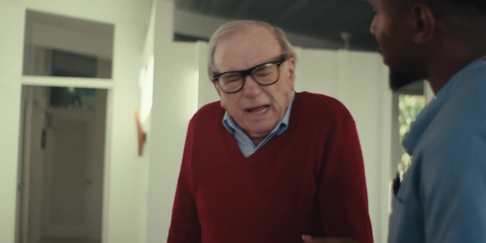 Elderly man talking to a nurse