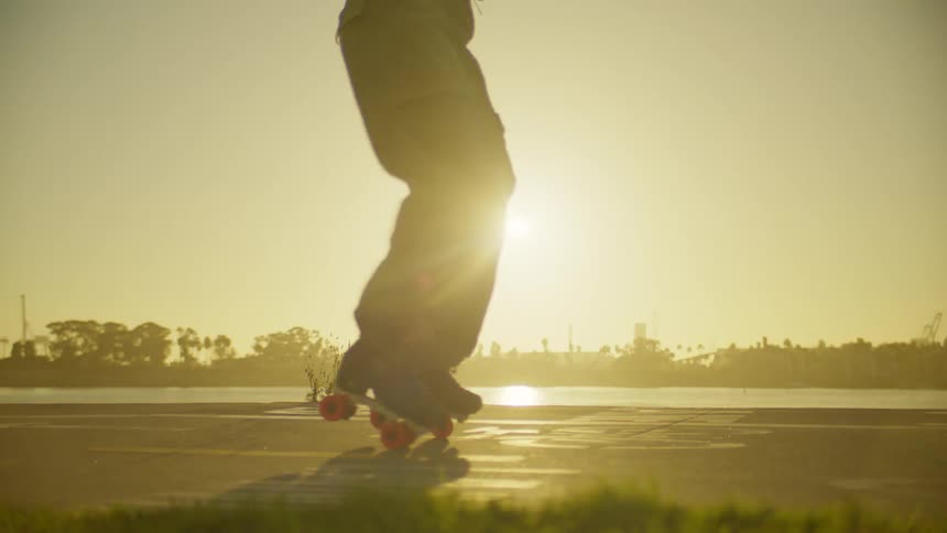 Legs of a person on roller skates spinning next to a lake
