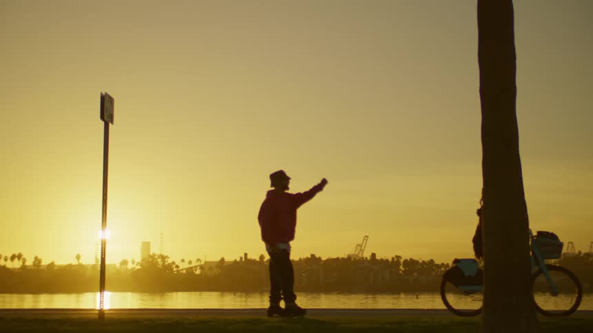 Man rollerblading next to woman on bike