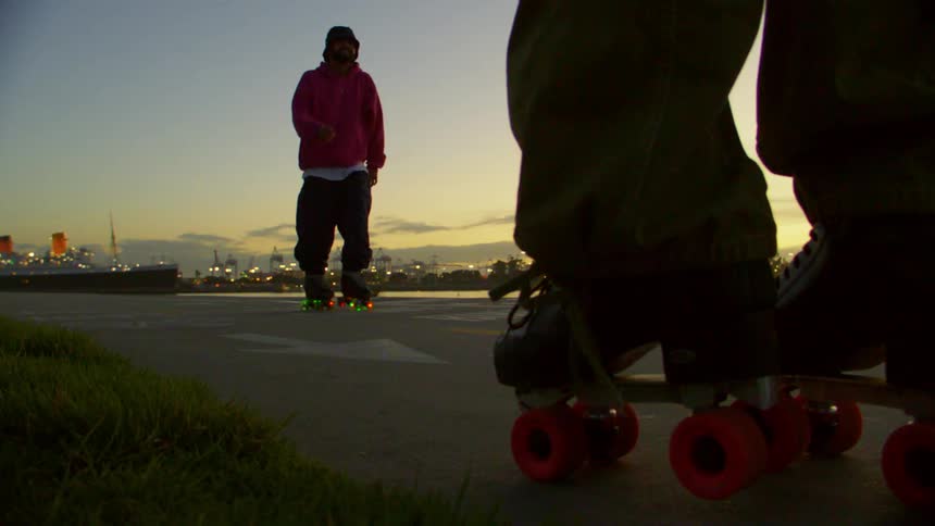 Lights flash on the roller skates of a man spinning