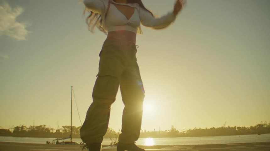 A woman spins around on her roller skates