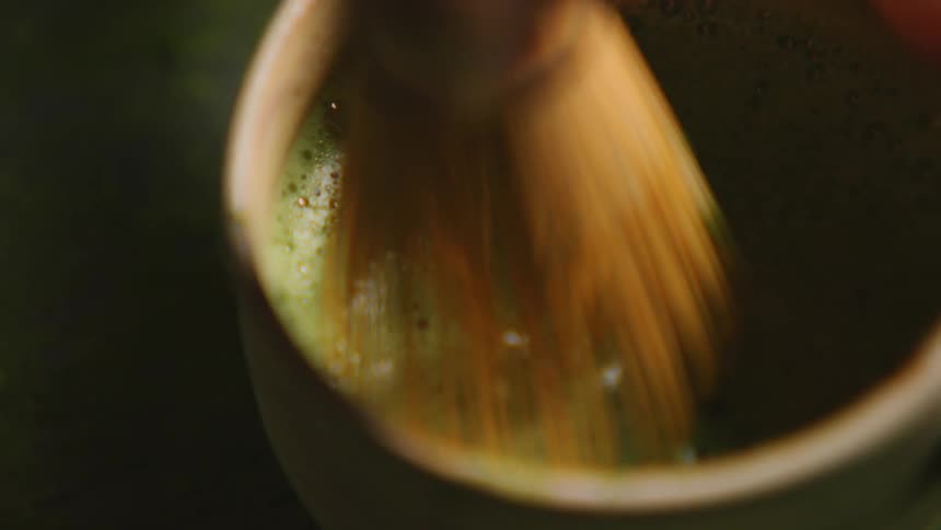 Close up of a paintbrush in a green liquid