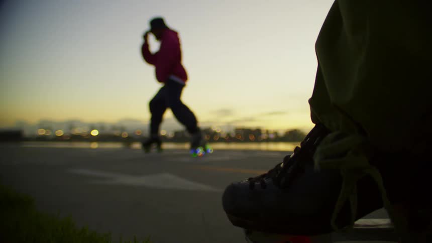 Man dancing on roller skates in the late afternoon