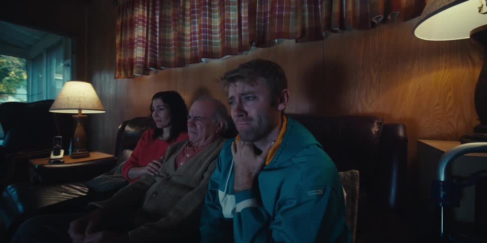 Family sitting on the couch watching together and with emotional expressions