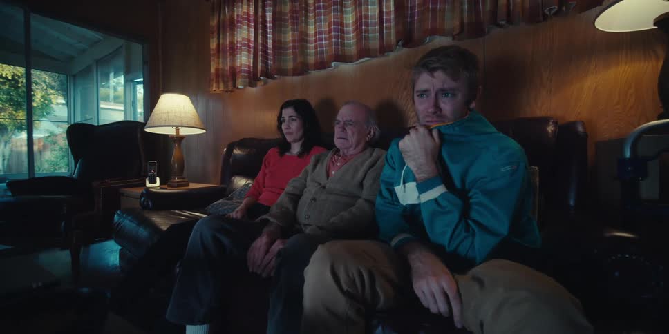 People are watching something sad on the television