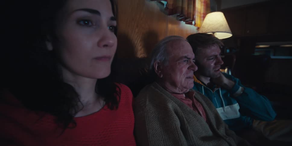 People are watching something sad on the television