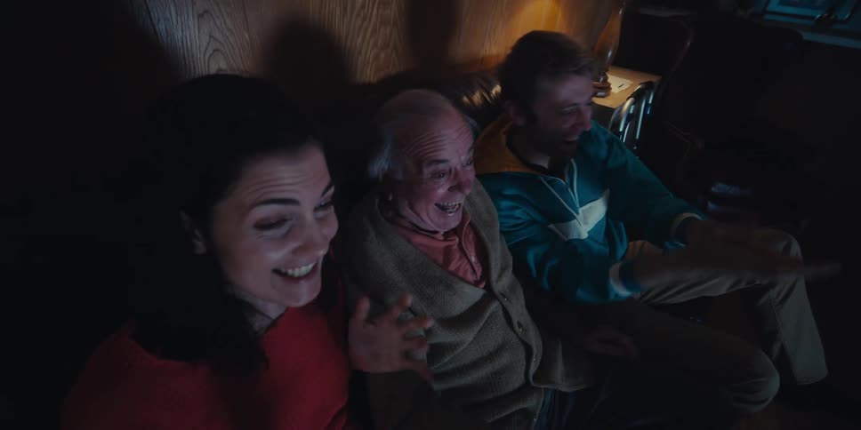 People cheer and clap at the television