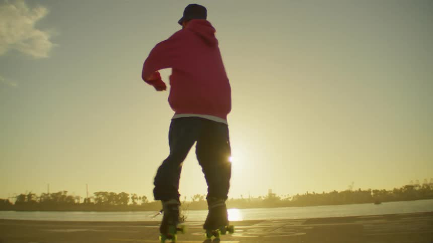 A man spins and dances on roller skates