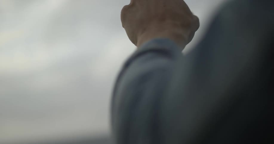 A man outstretches his hand into the air