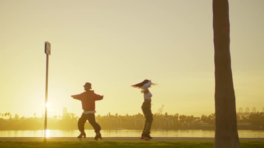 Man and woman spinning on roller skates