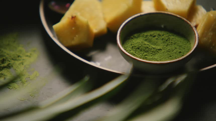 Green tea powder next to chopped fruit